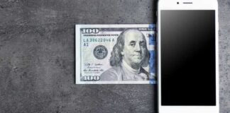 mobile phone money on grey background