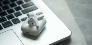 Apple Airpods Sitting On Top Of A Macbook