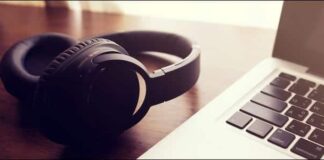Bluetooth Headphones Laying Next To A Mac